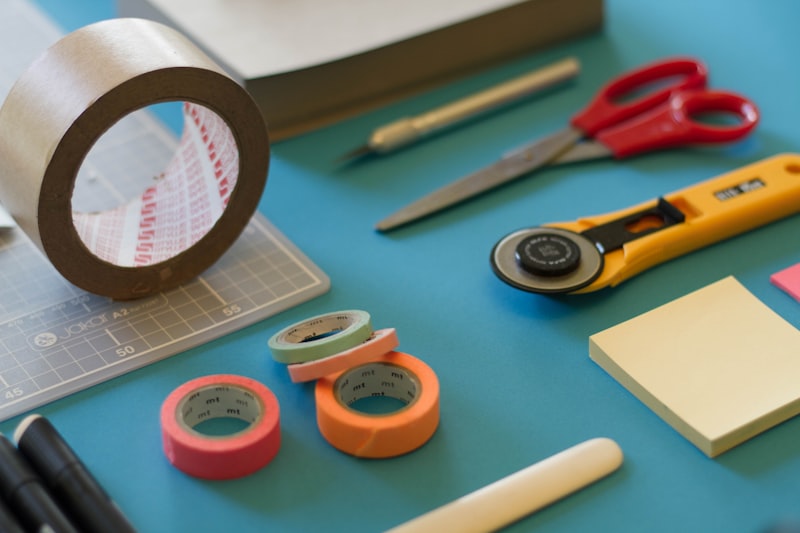 Arts and crafts table with colored paper, scissors, yarn, and DIY tools