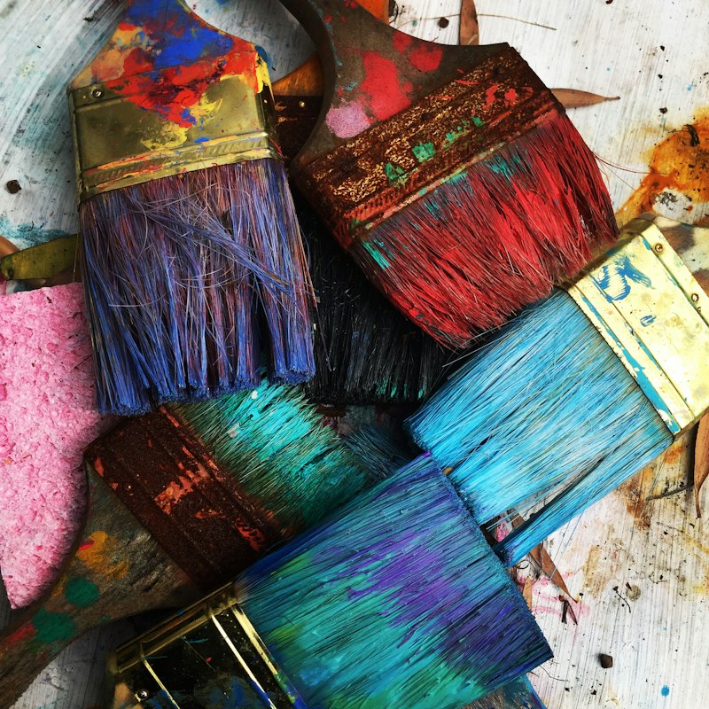 Artist acrylic paint tubes, brushes and color palette in studio